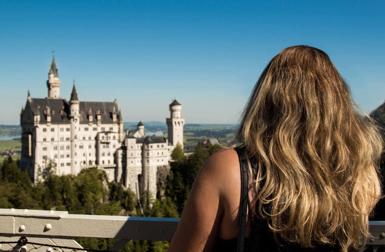 View from Marienbrücke (Queen Mary's Bridge) // Neuschwanstein Castle is Germany's most photographed and popular fairytale castle. Keep reading for a complete guide to visiting Neuschwanstein Castle including photos, how to get there from Munich, how to buy tickets and more. 