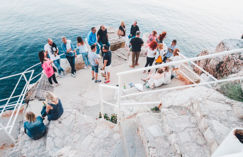 People drinking at a cliff bar in Dubrovnik